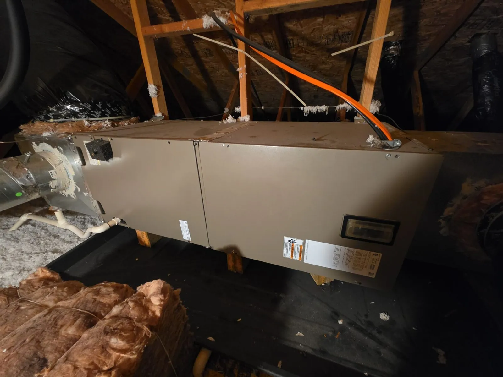 Horizontal furnace mounted between attic rafters with new venting