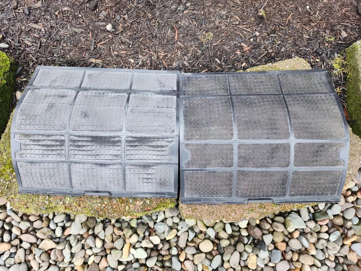 Two mini split filters side by side, one dusty and one cleaned
