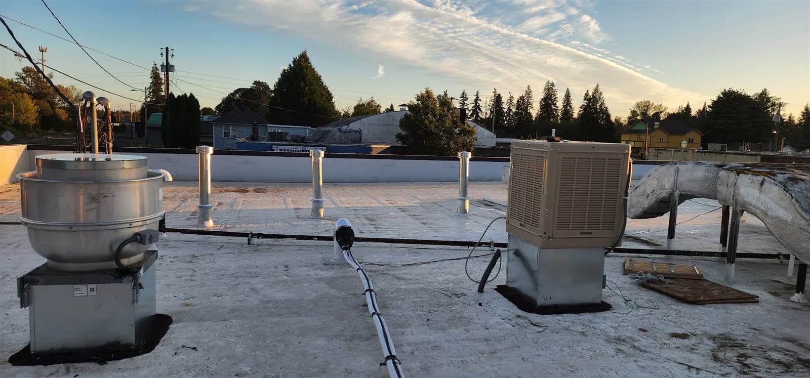 Upblast exhaust fan and rooftop unit on a commercial flat roof