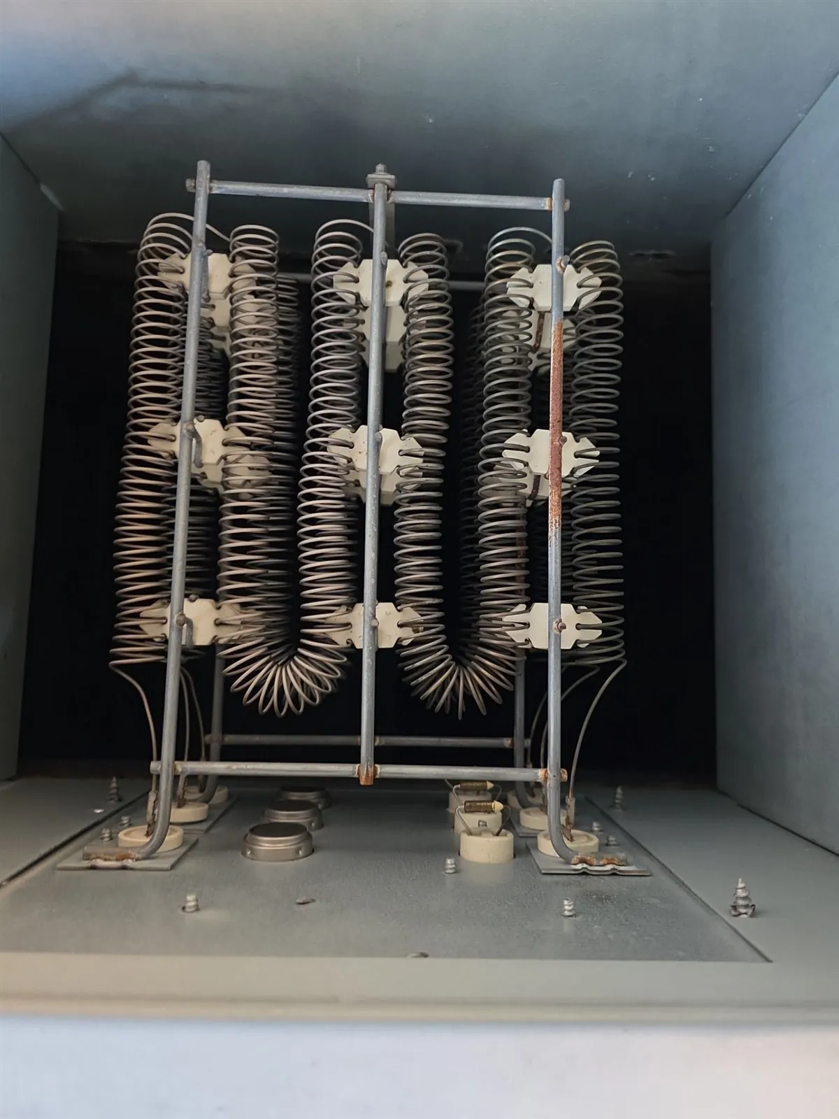 Electric heating element coils inside an air handler with the panel removed