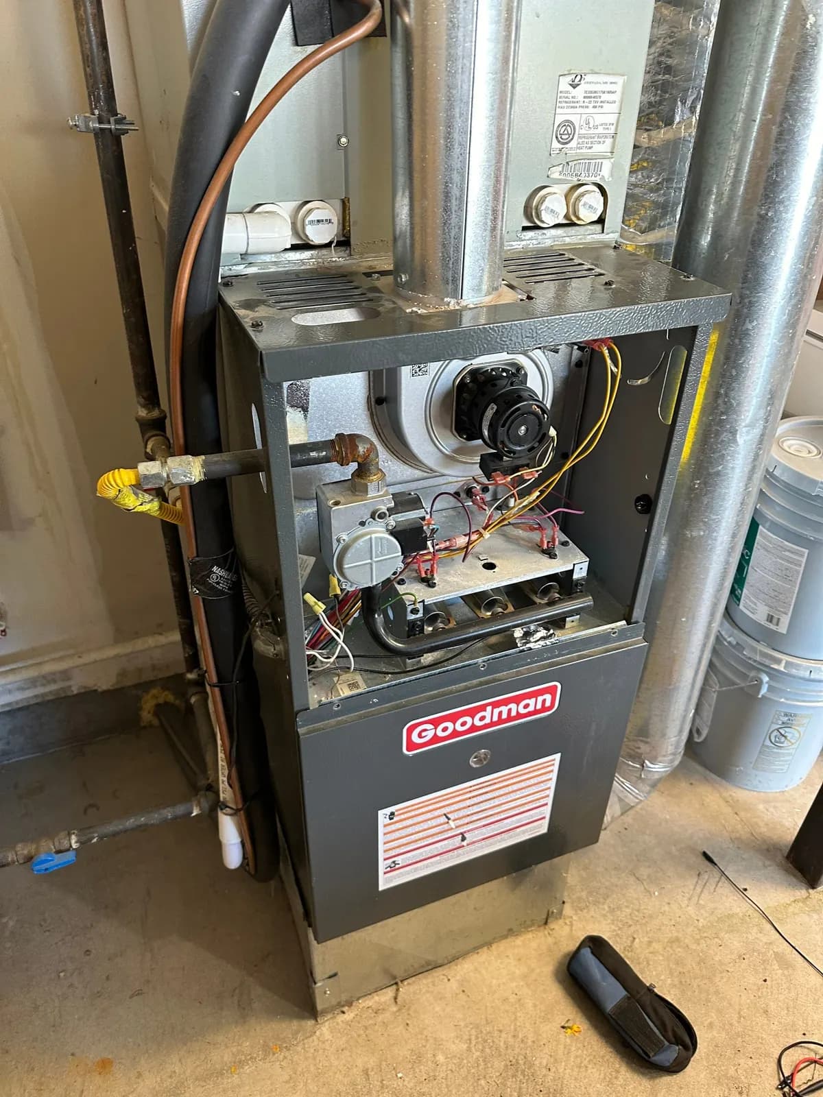 Gas furnace with the upper panel removed showing the inducer motor, gas valve, burners and wiring