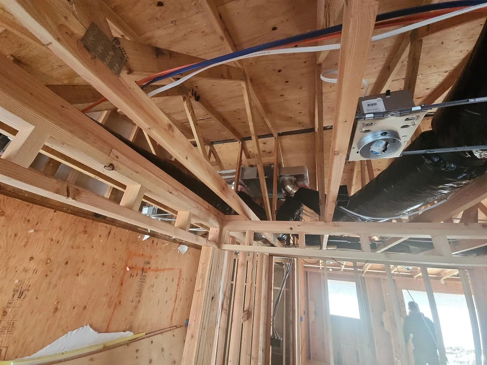 Duct runs and ceiling boxes installed in open framing on a new construction project