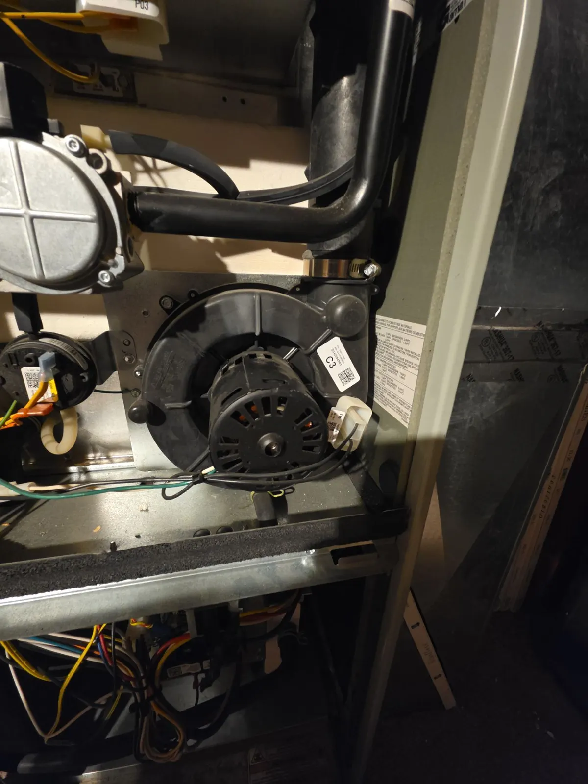 New inducer motor installed on an open high-efficiency gas furnace