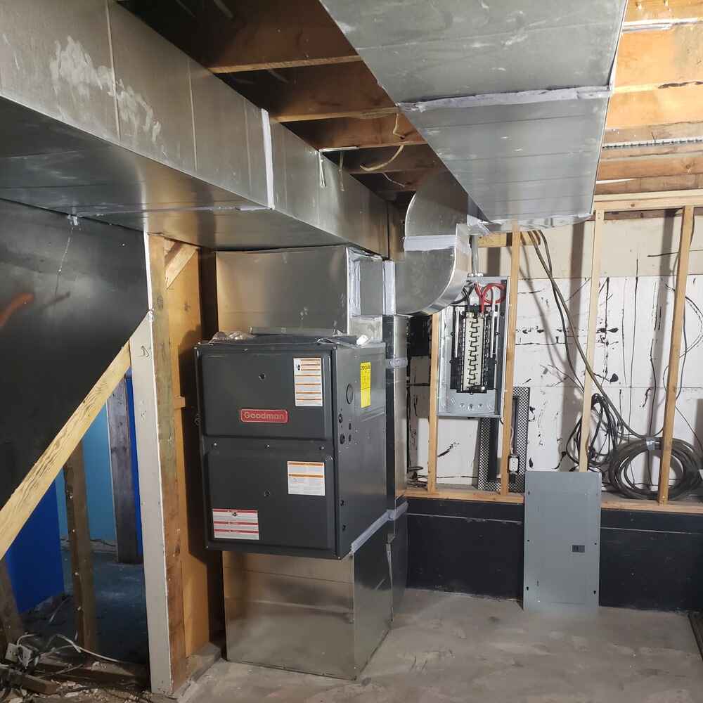 New gas furnace upgrade featuring a high-efficiency Lennox unit with freshly installed ductwork in an unfinished basement.