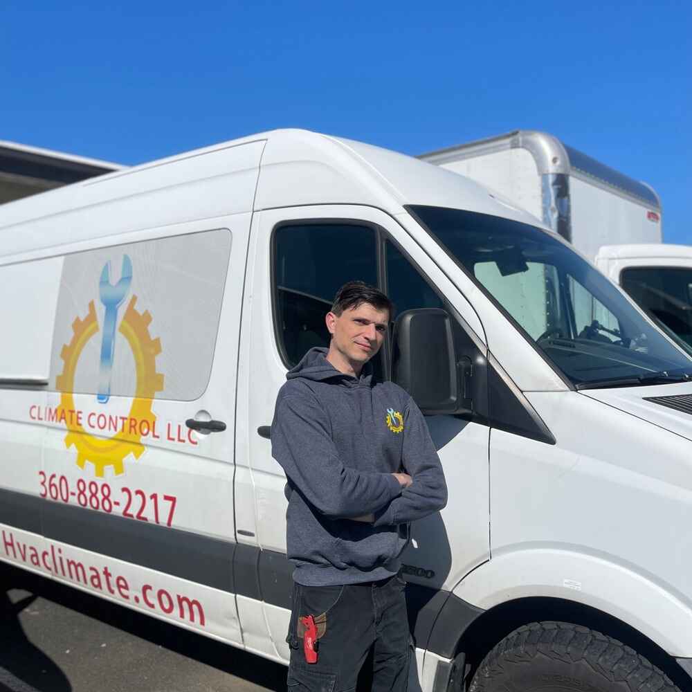 Licensed HVAC contractor installing residential air conditioning unit in Battleground WA