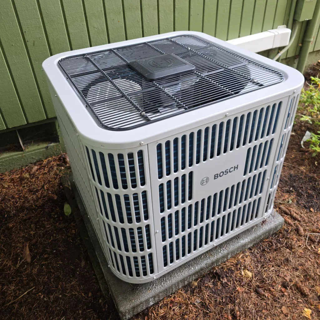 New Bosch outdoor unit installed by HVA Climate Control on a concrete pad beside a home
